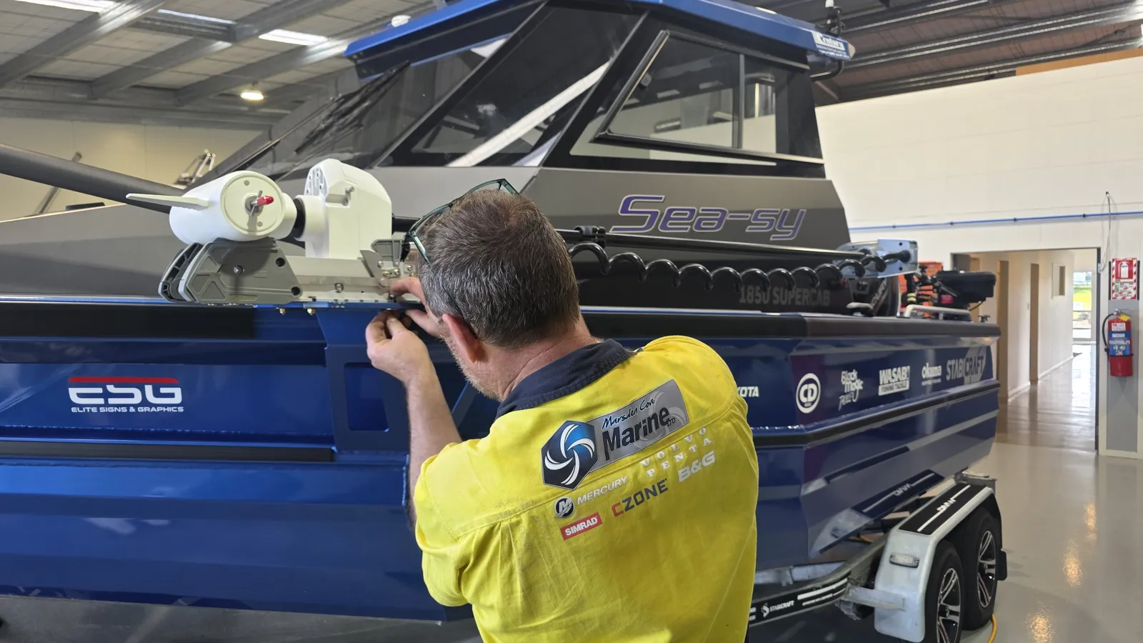 MCM technician fitting a Simrad RECON trolling motor at the workshop