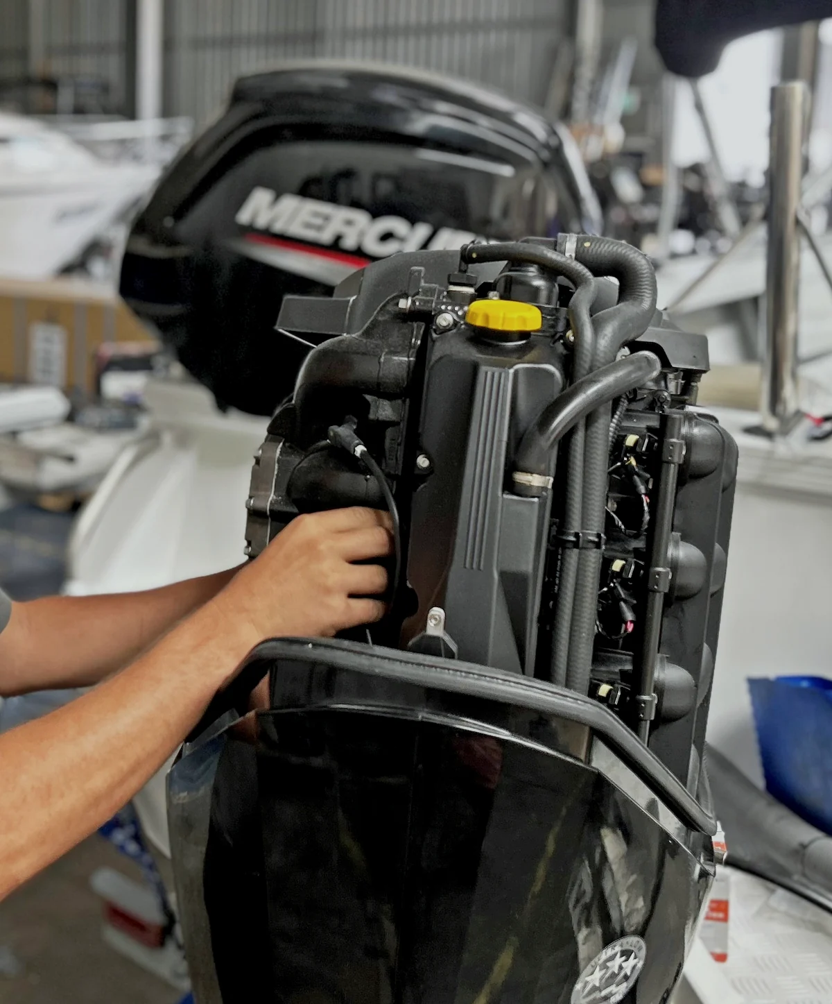 Marsden Cove Marine technician servicing a Mercury outboard in the workshop
